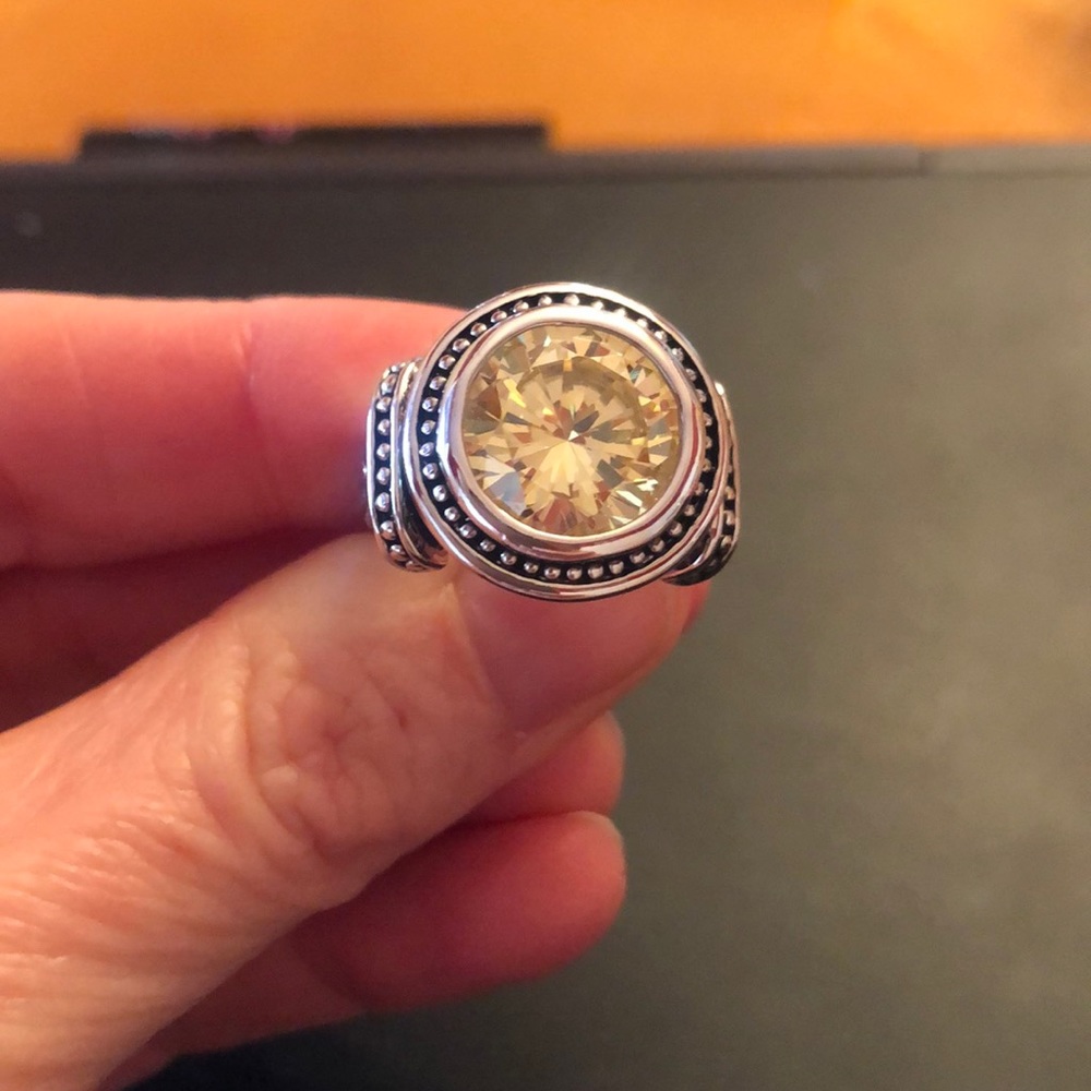 Silver ring with a yellow stone.